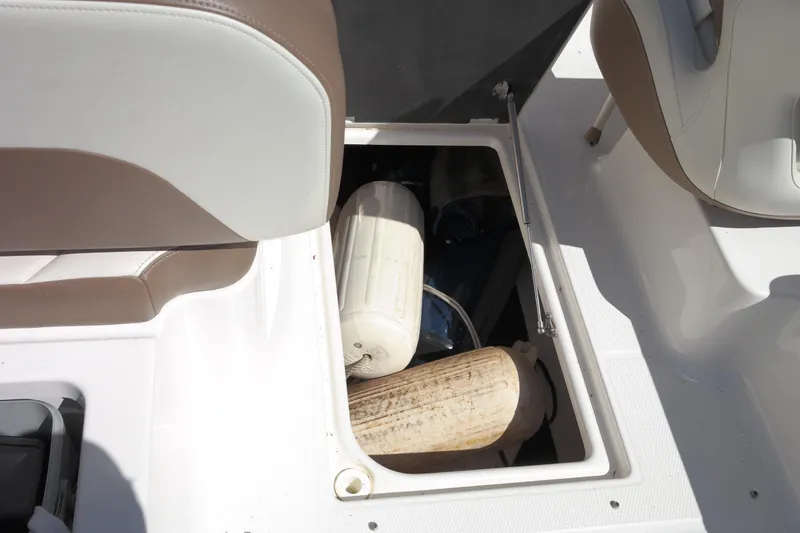 Slide: The Image of Storage compartment on 2015 Chaparral 250 Suncoast boat with fenders inside. - 33