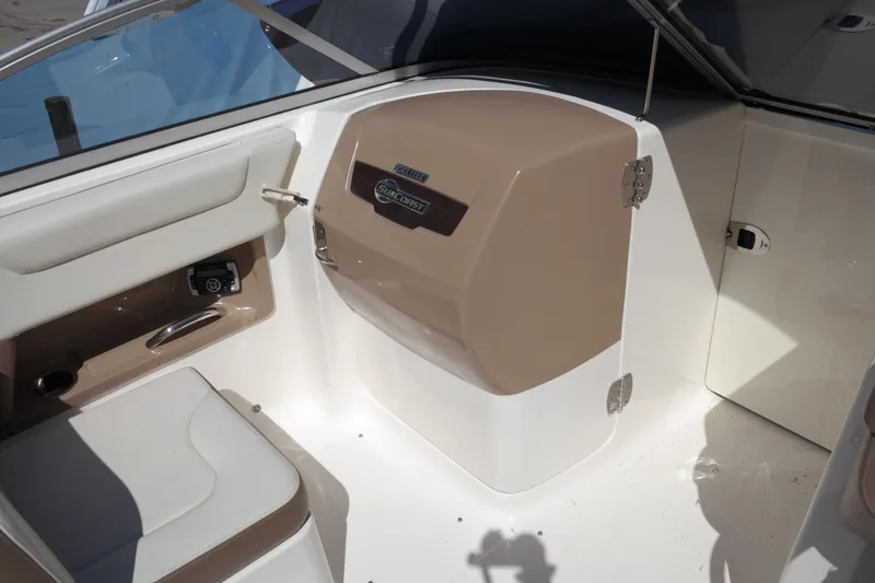 Slide: The Image of Interior of 2015 Chaparral 250 Suncoast boat, featuring seating and storage compartment. - 35