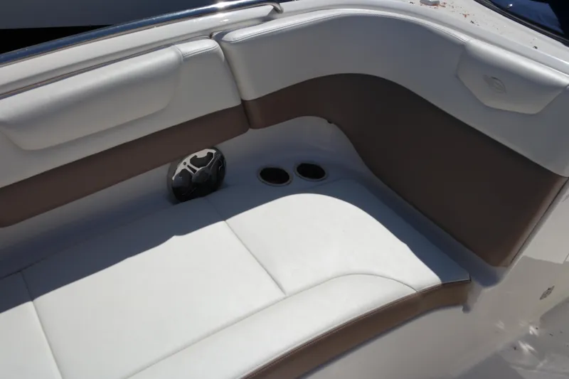 Slide: The Image of 2015 Chaparral 250 Suncoast boat interior with white and brown seating. - 9