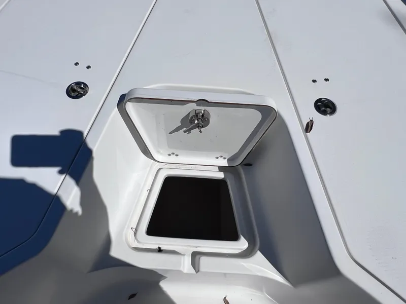 Slide: The Image of 2016 Sportsman Masters 227 Bay Boat storage compartment with open hatch. - 18