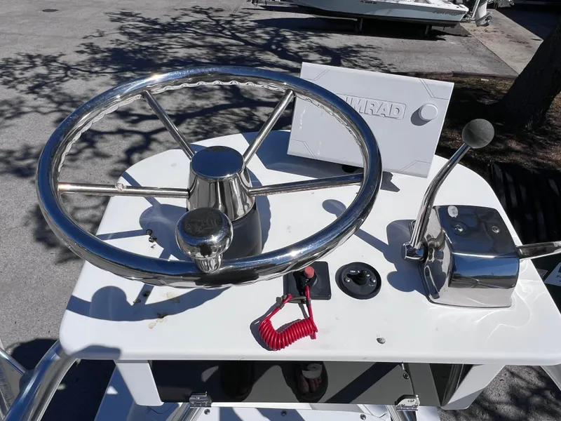 Slide: The Image of Steering console of 2016 Sportsman Masters 227 Bay Boat with chrome wheel and controls. - 24