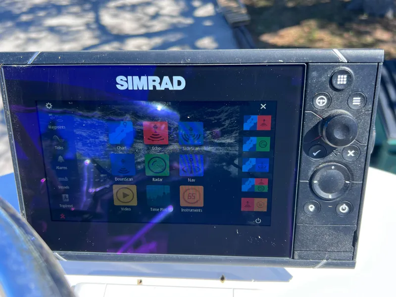 Slide: The Image of Simrad navigation system on 2016 Sportsman Masters 227 Bay Boat dashboard. - 26