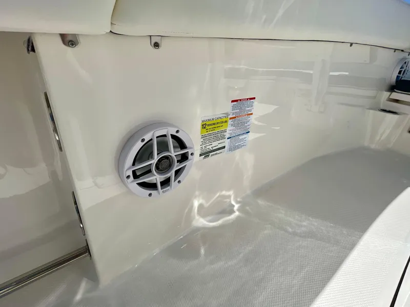 Slide: The Image of 2022 Robalo R230 Center Console interior with speaker and safety labels. - 23