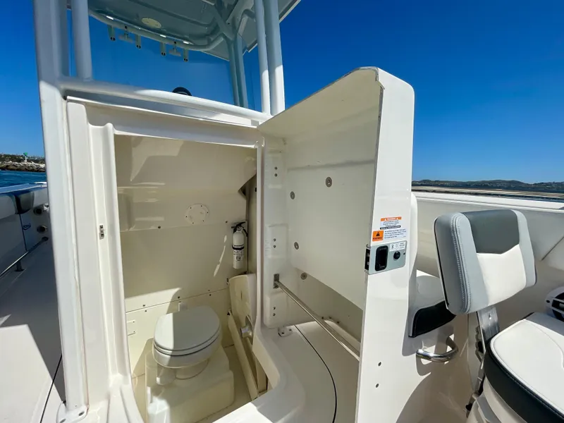 Slide: The Image of 2022 Robalo R230 Center Console boat interior with open storage compartment and seating. - 25