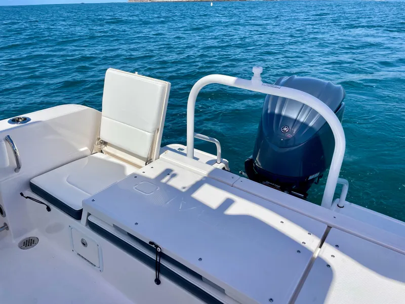 Slide: The Image of 2022 Robalo R230 Center Console boat with outboard motor on blue ocean. - 27