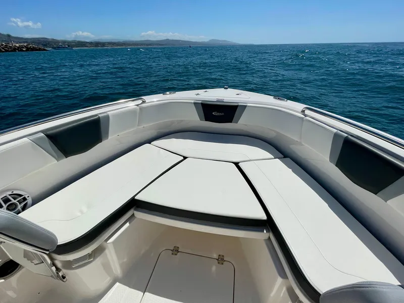 Slide: The Image of 2022 Robalo R230 Center Console boat on open water, featuring spacious seating. - 29