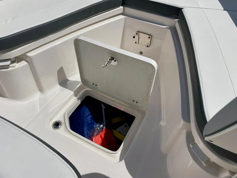 Slide: The Image of 2022 Robalo R230 Center Console boat with open storage compartment. - 30