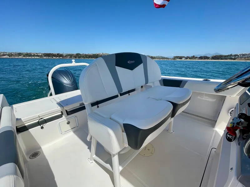 Slide: The Image of 2022 Robalo R230 Center Console boat interior with seating, on a sunny day at sea. - 31