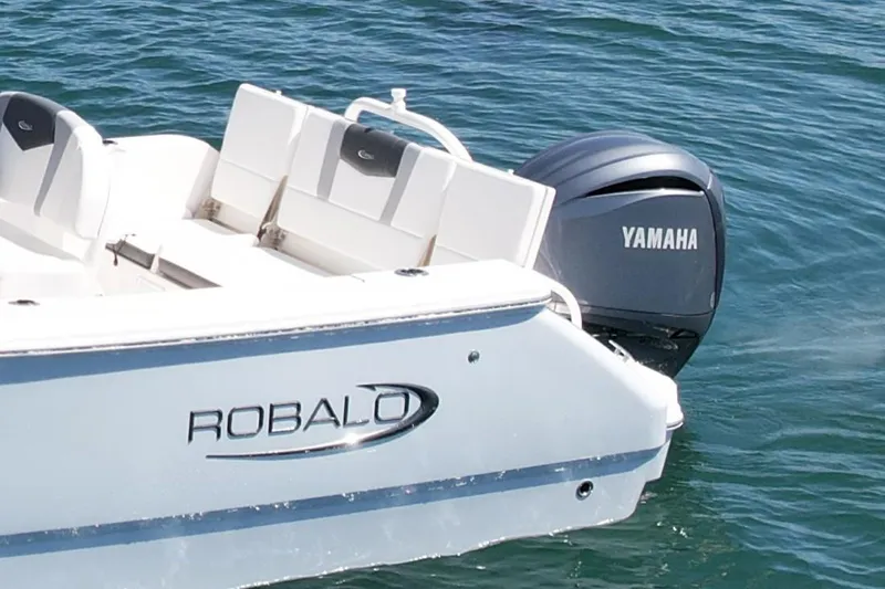 Slide: The Image of 2022 Robalo R230 Center Console boat with Yamaha engine on water. - 5