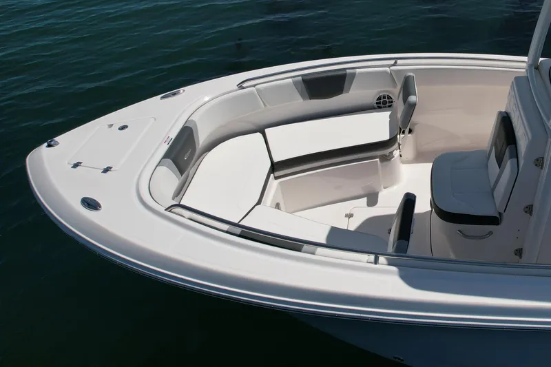 Slide: The Image of 2022 Robalo R230 Center Console boat with spacious seating area on calm water. - 7