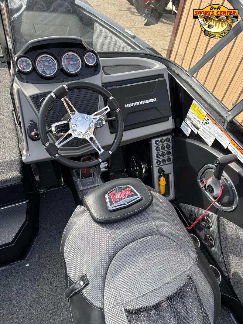 Slide: The Image of 2021 Ranger 1880MS boat dashboard with steering wheel and control panel. - 7