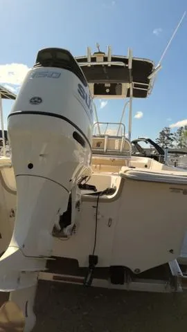 Slide: The Image of 2018 Carolina Skiff 238 DLV boat with Suzuki outboard motor, viewed from the rear. - 11