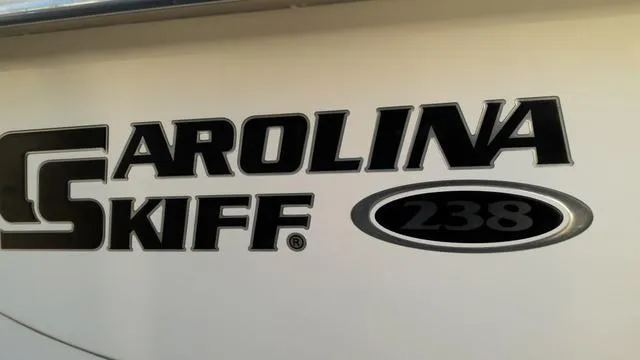 Slide: The Image of Carolina Skiff 238 DLV 2018 logo on boat exterior. - 12