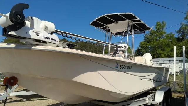 Slide: The Image of 2018 Carolina Skiff 238 DLV boat with Minn Kota motor on trailer, sunny day. - 9