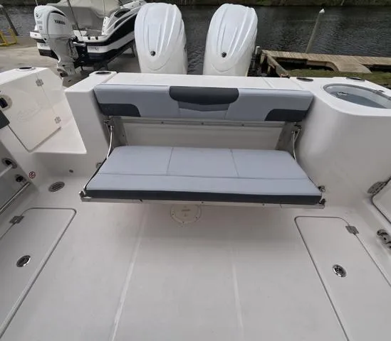 Slide: The Image of 2025 Robalo 257 Dual Console boat with foldable rear seating and twin engines. - 13