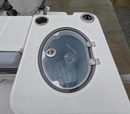 Slide: The Image of 2025 Robalo 257 Dual Console livewell with transparent lid and cup holders. - 14