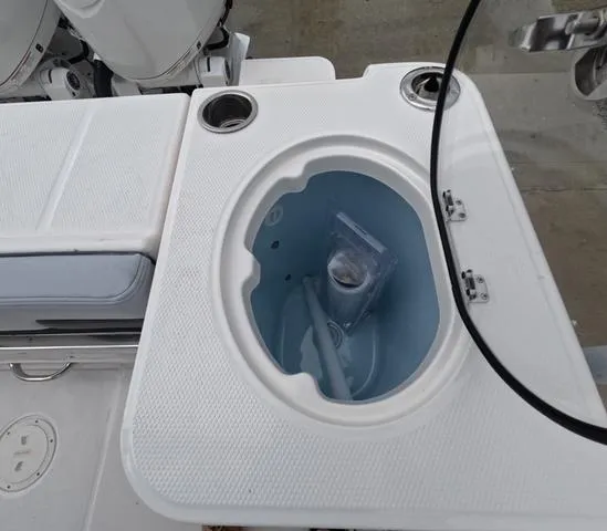 Slide: The Image of 2025 Robalo 257 Dual Console boat livewell with cup holders and storage compartment. - 15