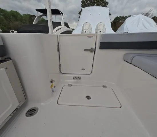 Slide: The Image of 2025 Robalo 257 Dual Console boat interior with storage compartments and seating. - 17