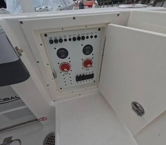 Slide: The Image of 2025 Robalo 257 Dual Console boat control panel with open access door. - 19