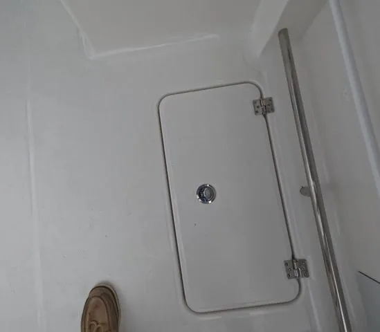 Slide: The Image of 2025 Robalo 257 Dual Console boat deck with storage hatch and railing. - 21