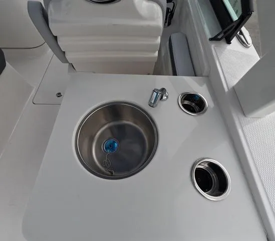 Slide: The Image of 2025 Robalo 257 Dual Console boat sink and cup holders on deck. - 23