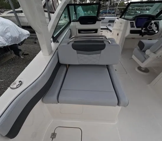 Slide: The Image of 2025 Robalo 257 Dual Console boat interior with gray seating and modern dashboard. - 24
