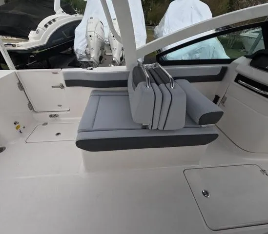 Slide: The Image of 2025 Robalo 257 Dual Console boat interior with gray seating and modern design. - 25