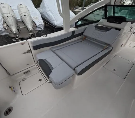 Slide: The Image of 2025 Robalo 257 Dual Console boat interior with gray seating and storage compartments. - 26