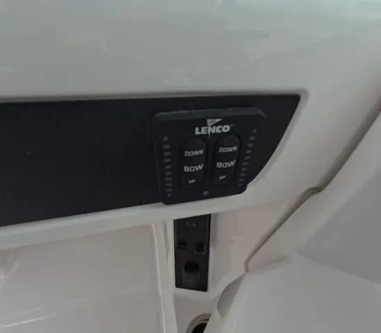 Slide: The Image of 2025 Robalo 257 Dual Console Lenco trim tab control panel. - 31