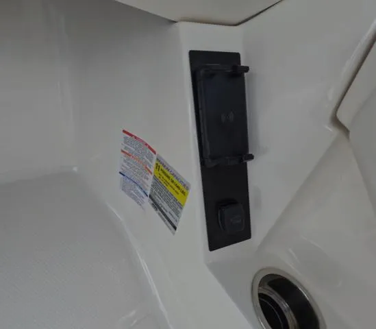 Slide: The Image of 2025 Robalo 257 Dual Console interior detail with control panel and safety labels. - 34