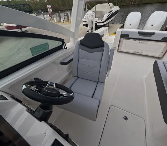 Slide: The Image of 2025 Robalo 257 Dual Console boat interior with steering wheel and seating. - 36