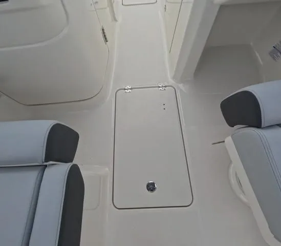 Slide: The Image of 2025 Robalo 257 Dual Console interior with sleek seating and storage compartment. - 38