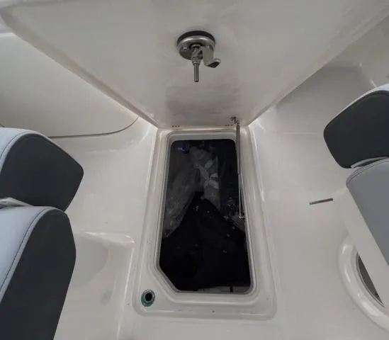 Slide: The Image of 2025 Robalo 257 Dual Console boat storage compartment with open hatch. - 39