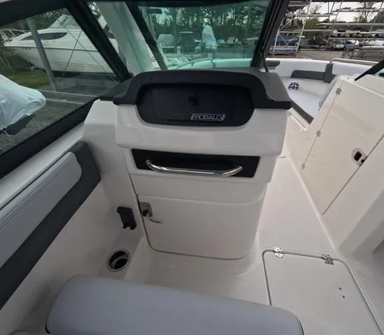 Slide: The Image of 2025 Robalo 257 Dual Console interior with helm and seating area. - 40