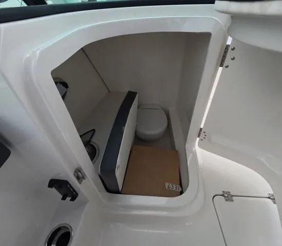 Slide: The Image of Interior of 2025 Robalo 257 Dual Console boat with compact toilet compartment. - 42