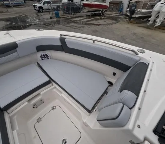 Slide: The Image of 2025 Robalo 257 Dual Console boat interior with cushioned seating and storage compartments. - 46