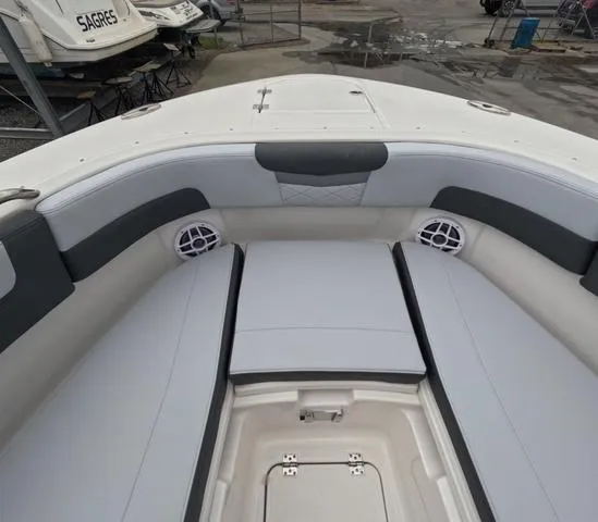 Slide: The Image of 2025 Robalo 257 Dual Console boat interior with cushioned seating and storage. - 48