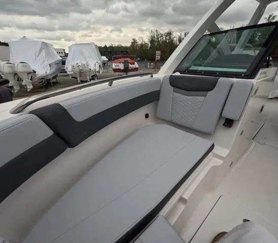 Slide: The Image of 2025 Robalo 257 Dual Console boat interior with gray seating and modern design. - 49