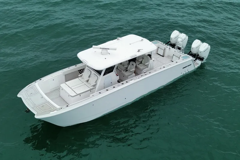 The Image of 2024 Twin Vee 400 GFX CC boat on open water, featuring sleek design and powerful engines. - 0