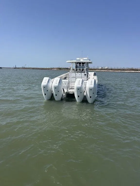 Slide: The Image of 2024 Twin Vee 400 GFX boat with multiple engines on open water. - 10