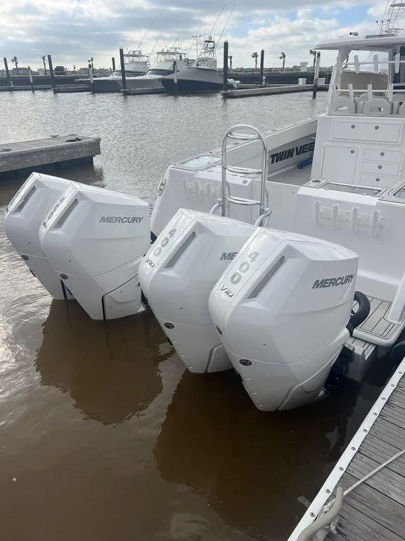 Slide: The Image of 2024 Twin Vee 400 GFX boat with triple Mercury outboard engines docked at marina. - 18
