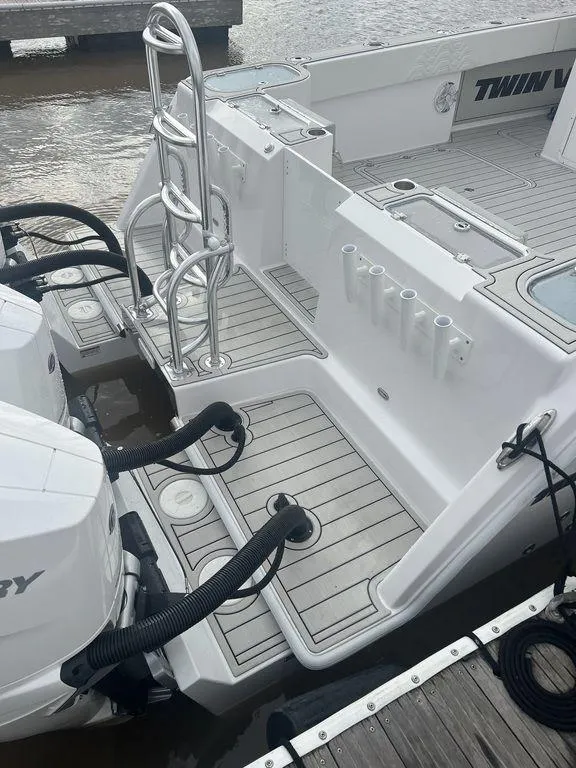 Slide: The Image of 2024 Twin Vee 400 GFX boat with dual engines and sleek deck design. - 20