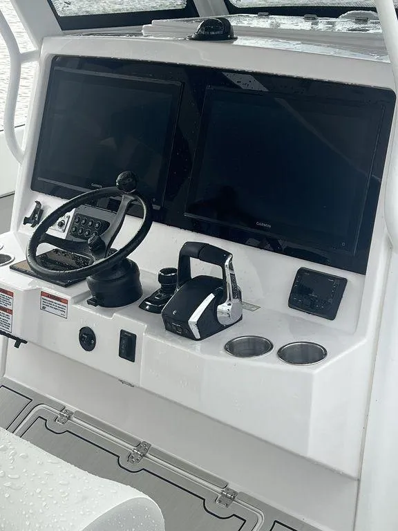 Slide: The Image of 2024 Twin Vee 400 GFX boat dashboard with dual screens and controls. - 22