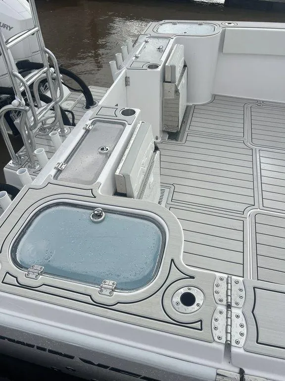 Slide: The Image of 2024 Twin Vee 400 GFX boat deck with storage compartments and sleek design. - 24