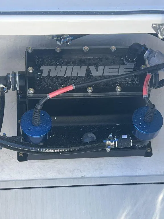 Slide: The Image of 2024 Twin Vee 400 GFX engine compartment with visible wiring and components. - 29