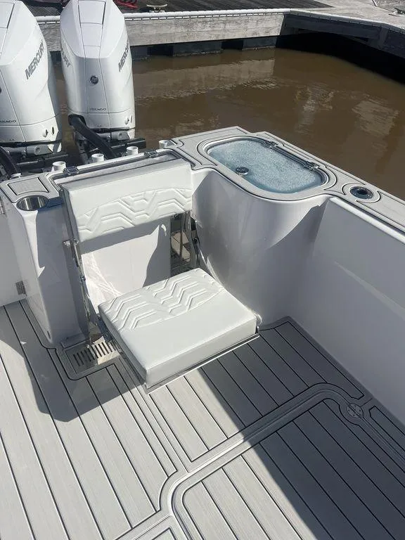 Slide: The Image of 2024 Twin Vee 400 GFX boat interior with seating and twin Mercury engines. - 32