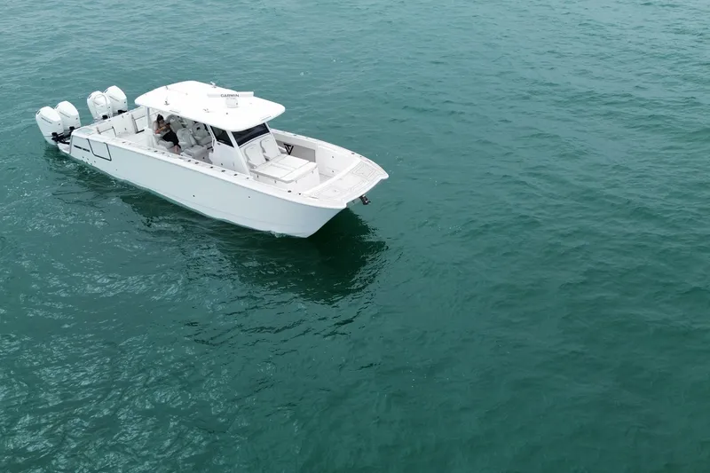 Slide: The Image of 2024 Twin Vee 400 GFX CC boat cruising on open water. - 34
