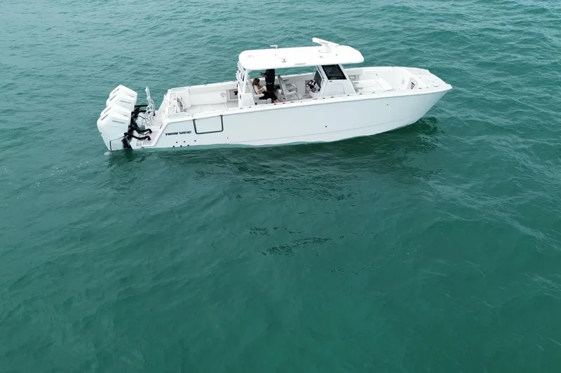 Slide: The Image of 2024 Twin Vee 400 GFX CC boat cruising on open water. - 35