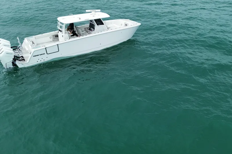 Slide: The Image of 2024 Twin Vee 400 GFX CC boat cruising on open water. - 36
