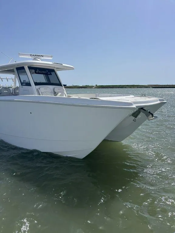 Slide: The Image of 2024 Twin Vee 400 GFX boat on water under clear blue sky. - 4
